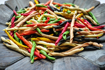 Traditional colorful Italian dried homemade pasta fusilli with eight colors