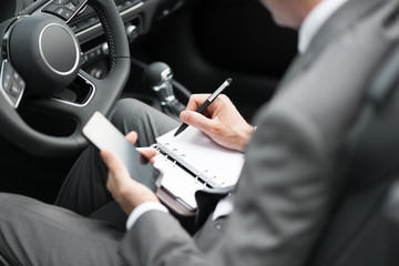 Businessman working on his car