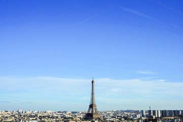 View on Eiffel Tower and Paris Skyline from Arc de Triomphe in the sunny day with blue sky background
