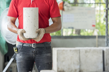 Technician checking of concrete quality during cube demolition t