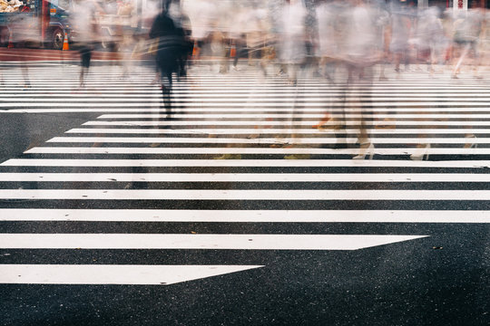 Pedestrians Crossing At Intersection In Shinjuku Tokyo Japan