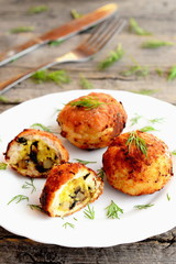 Fried meat patties stuffed with cheese and fried mushrooms. Stuffed meat patties on a plate and on wooden background. Home cuisine. Closeup
