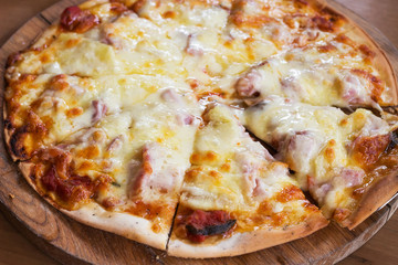 Crispy pizza hawaiian with ham and pineapple