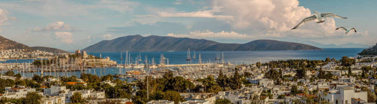 Travel on Aegean Sea. Panorama of Bodrum harbor with yacht and island.