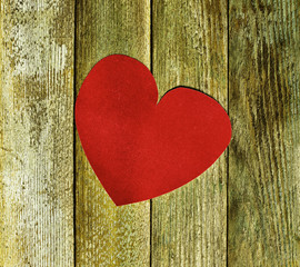 Big red heart velvet paper on old wooden boards close up. The concept of love, Valentine's day. tinted photo