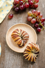 Breakfast with chocolate croissants and fresh grape on old woode