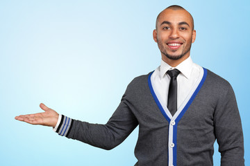 Happy successful businessman pointing on copy space