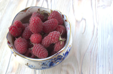 Sweet raspberries on plate