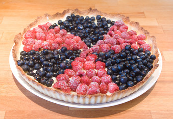 Biohazard sign berry pie with frozen raspberry and fresh bilberry on a wooden board - 120162789