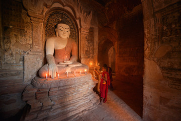 Buddha statue light candle in ancient temple,lowlight, Bagan Myanmar