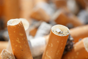 Big pile of put out cigarettes in an ashtray
