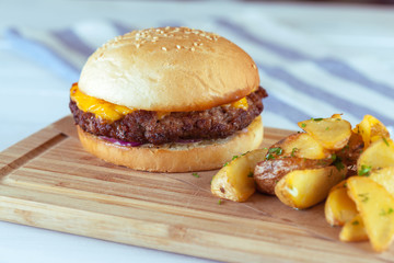 burger and french fries on wooden table