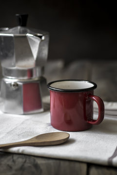 esspresso pot and red coffee cup on table