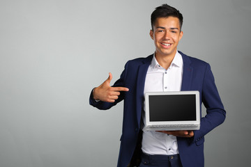 Portrait of smiling young man with laptop