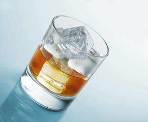 Glass of scotch whiskey and ice studio photo