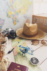 Map and accessories of traveler on wooden background