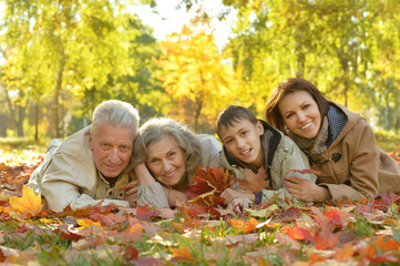 Happy family relaxing in autumn forest