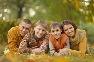 Happy family in autumn forest