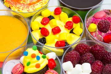 dessert in plastic cups cream with fruit and pastries and mousse