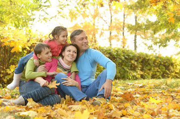 Happy family in autumn park