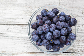 Fresh plums in cup