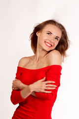 smiling woman in red posing against white background. studio iso