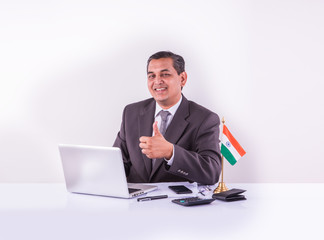 office, business, technology, finances and internet concept - smiling indian businessman with...
