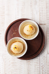 Homemade stuffed or baked pear with white wine, honey and nuts in a bowl, closeup