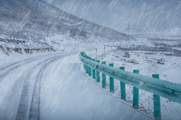 Fototapeta premium Road cover with snow in a snow blizzard and fog