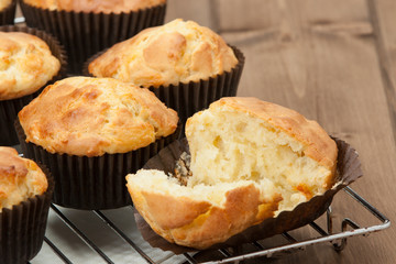 Homemade Cheddar Muffins In Paper Cases. Wooden Table.