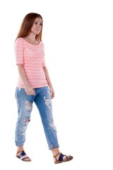 Obraz premium back view of walking woman . beautiful redhead girl in motion. backside view of person. Rear view people collection. Isolated over white background. 