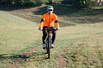 Young man traveler riding on bicycle with red backpack