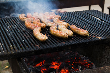 BBQ with fiery sausages on the grill