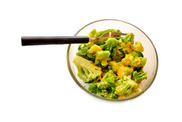 Cheesy Broccoli Served in a Glass Bowl Over White