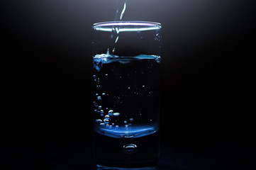 A shot of vodka on a black background.