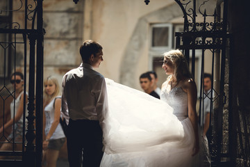 Fototapeta premium fragile woman and her husband speak at the high gates