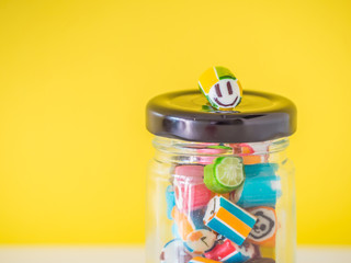 Closeup at smiley face candy cane put on the top of glass jar