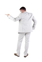 Businessman pointing at wall. rear view. Isolated over white . 