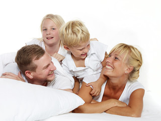 Happy family in bed