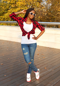 Beautiful smiling african woman wearing a sunglasses, red checke