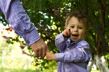 the parent holding the child's hand with a happy background