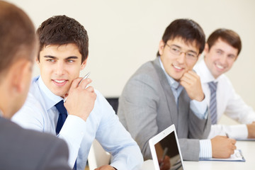 Young businessmen sitting at seminar