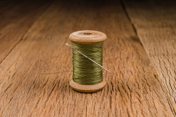 retro wooden spool thread with needle