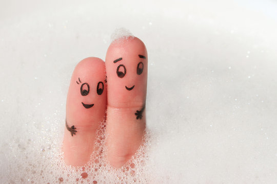 Finger art of Happy couple bathe in bath with foam.