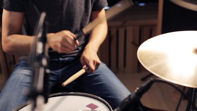 male musician playing drums and cymbals at concert