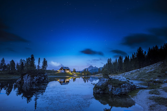 Italy, Veneto, Dolomites, Lake Federa and Croda da Lago mountain hut by night