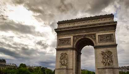 Fototapeta na wymiar Triumphal arch in Paris city at sunset. Arc de Triomphe in Paris, France. Famous Paris view on triumphal arch