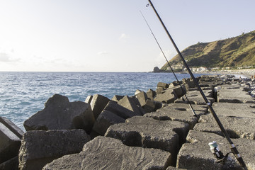 view first breakwater floor with fishing rods, italy