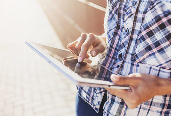 Young woman using digital tablet outdoors