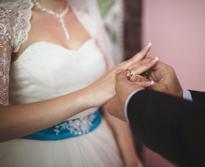 Obraz na płótnie Canvas Groom is giving a wedding ring to the bride